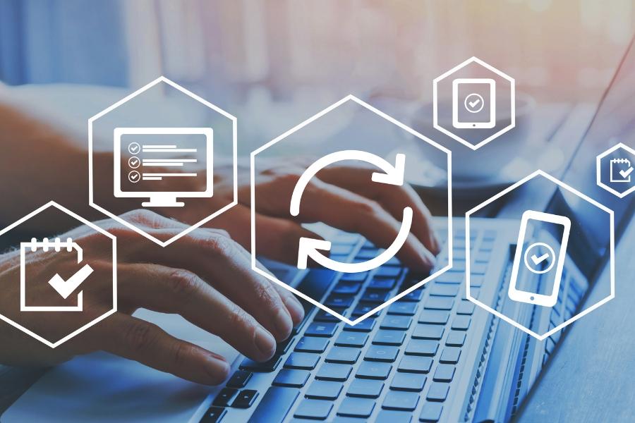 A person's hands are typing on a laptop with 6 white hectagon elements. 